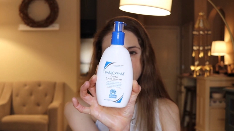 A person holding a bottle of Vanicream gentle facial cleanser