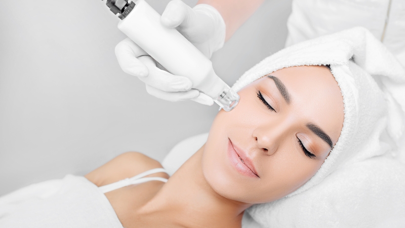 A woman receives radiofrequency skin tightening on her cheek to improve firmness and reduce fine lines