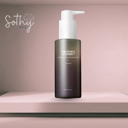 Bottle of Haruharu Wonder Black Rice Cleansing Oil (Fragrance-Free) displayed on a soft pink background with a spa logo
