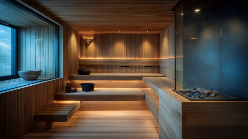 Modern wooden sauna interior prepared for a session after a facial treatment